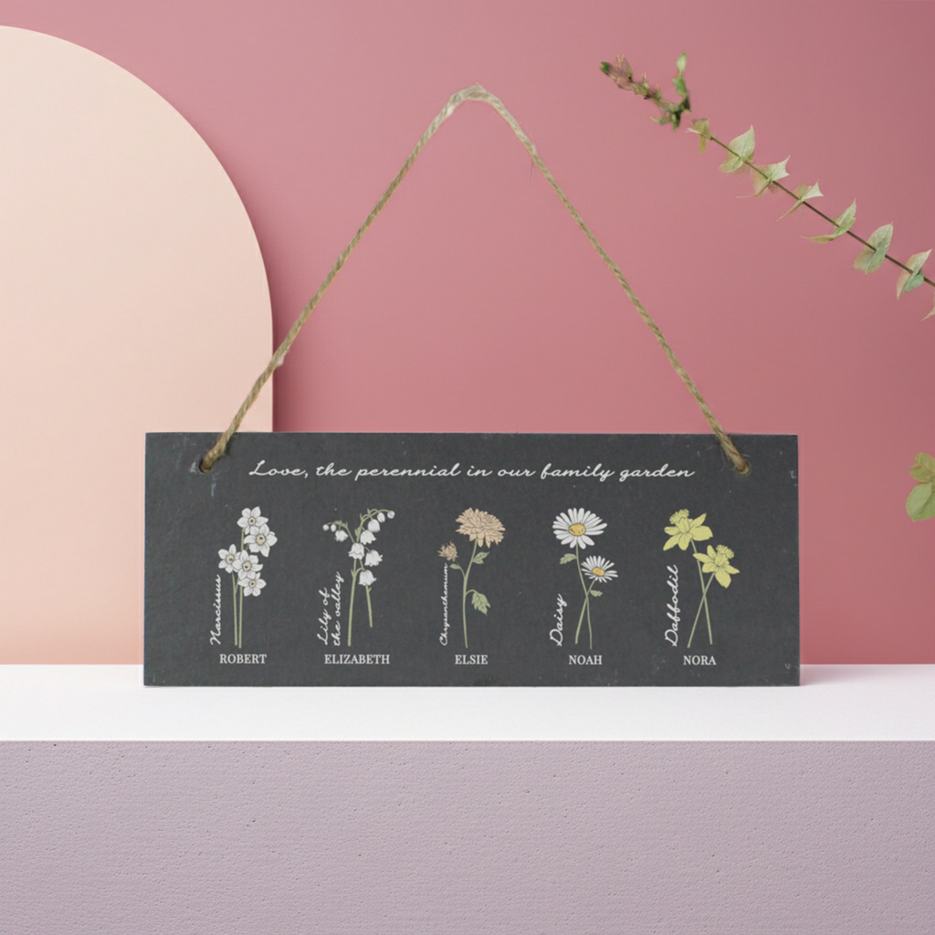 Decorative hanging sign with floral illustrations and names on a pink background