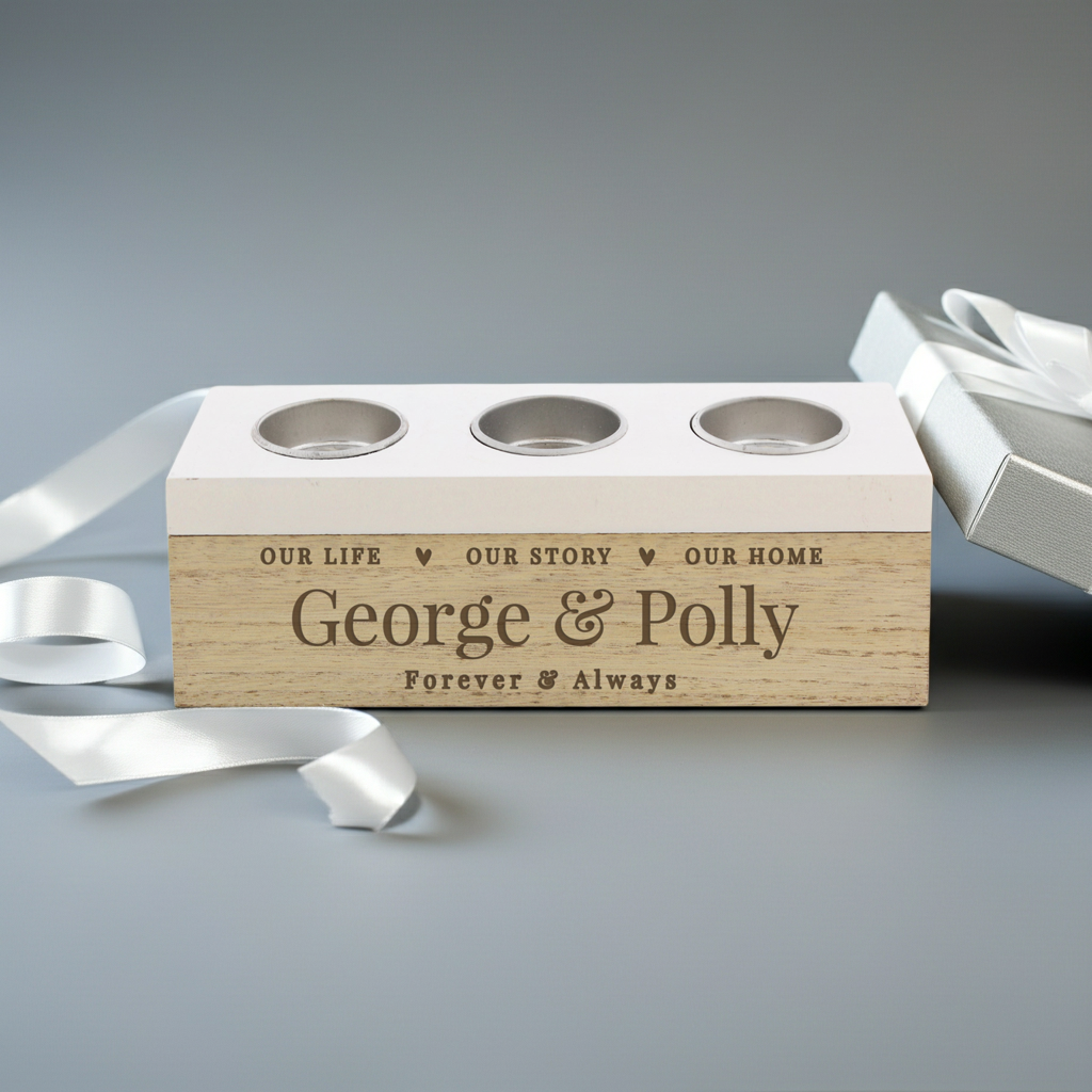 A personalized wooden keepsake box with three circular cutouts on top, engraved with the names 'George & Polly' and the phrase 'Forever & Always,' shown on a gray background with white ribbon and a white gift box.