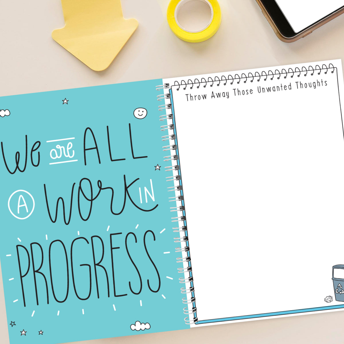 Notebook with motivational quote on a desk with office supplies