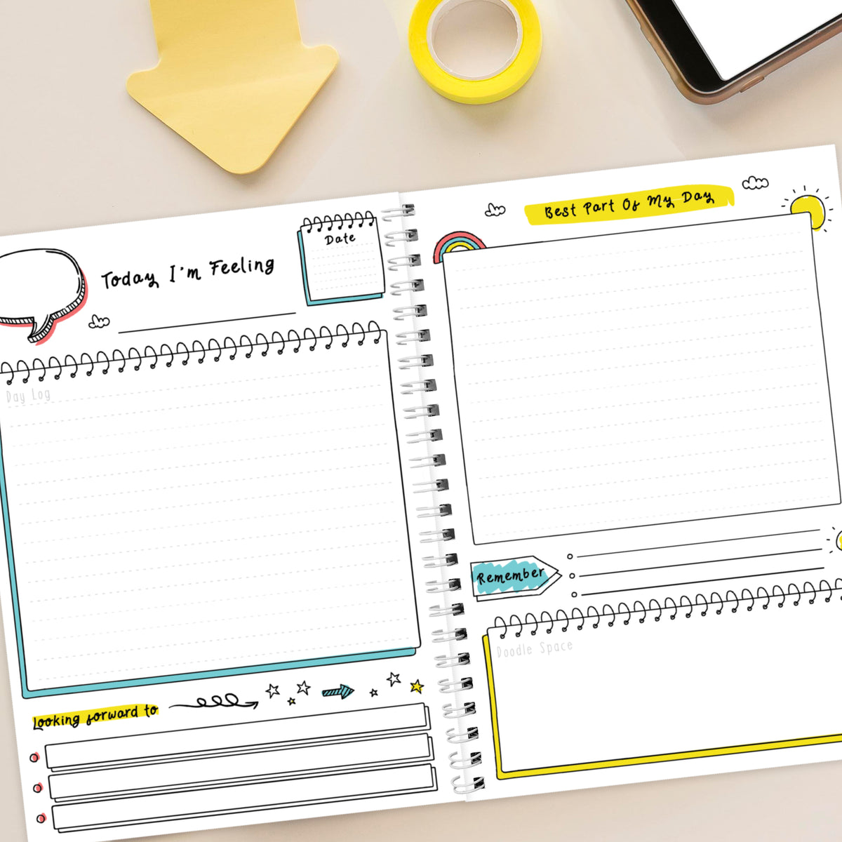 Notebook with various writing prompts on a desk with stationery items.